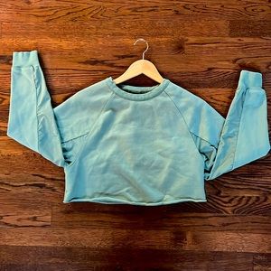 Alo cropped sweatshirt with cutout back and mesh sleeve insets.